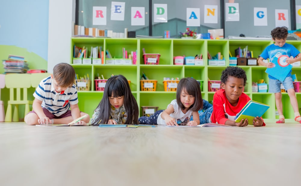 A diverse group of happy children cared for at A Step Above Day Care Academy.